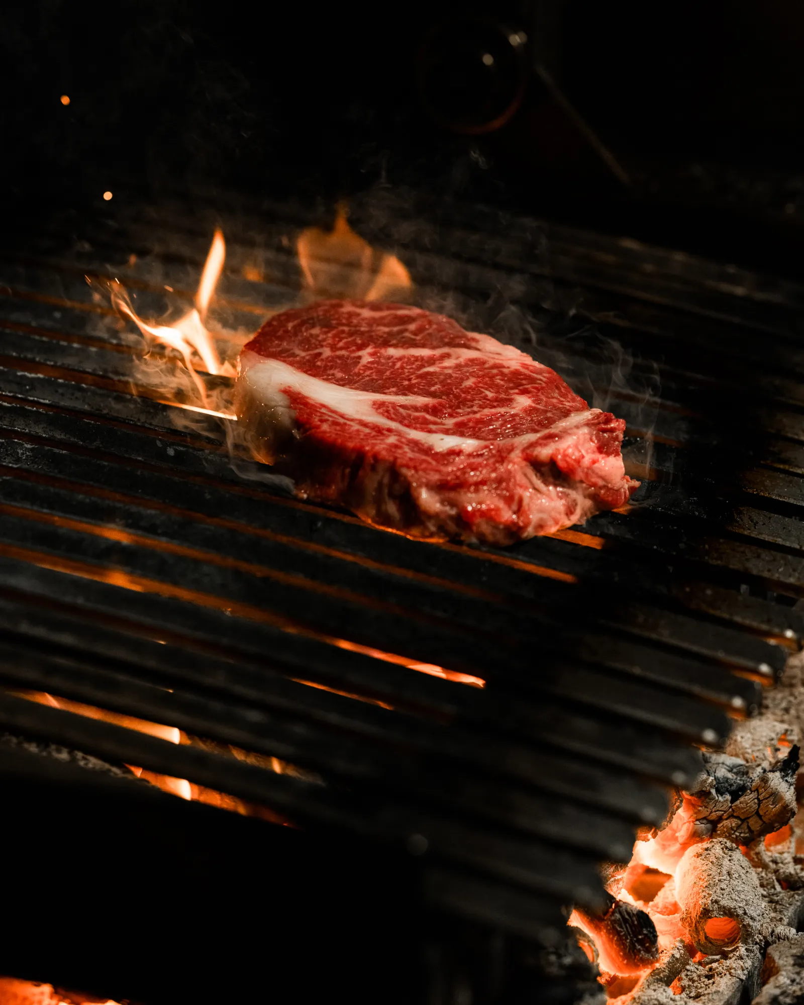 An exquisite wagyu steak from Carrara640, sears and throws off flames during the ShareStory commercial shoot.