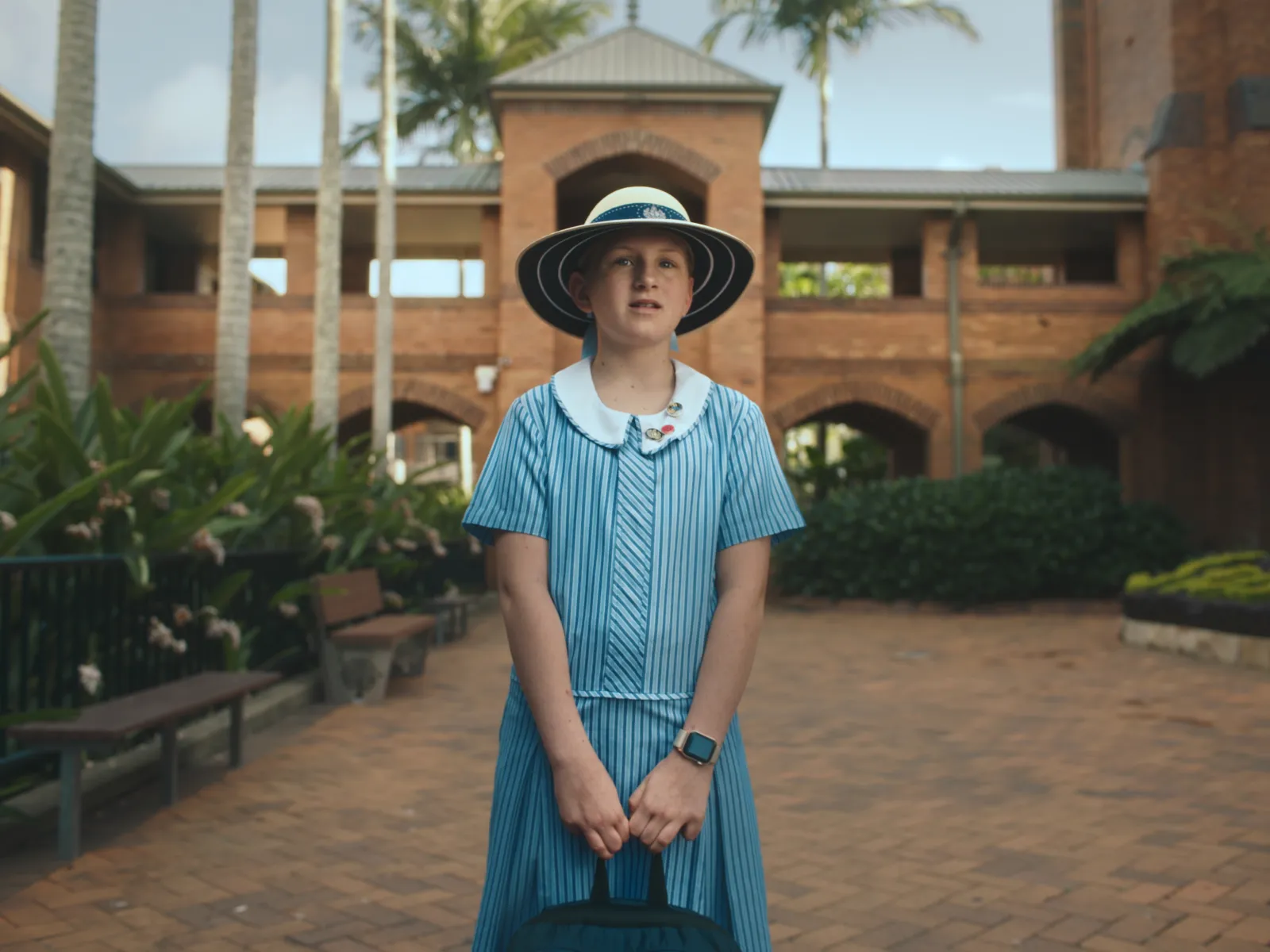 A school girl is dropped off for her first day at Stuartholme, not sure of what is to come.